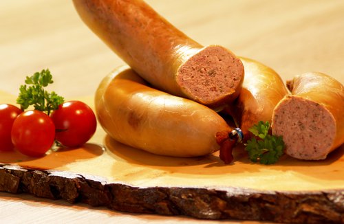 Aufgeschnittener Ring Leberwurst garniert mit Tomaten und Petersilie